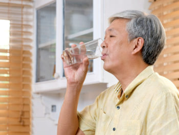 Senior man drinking a glass of water
